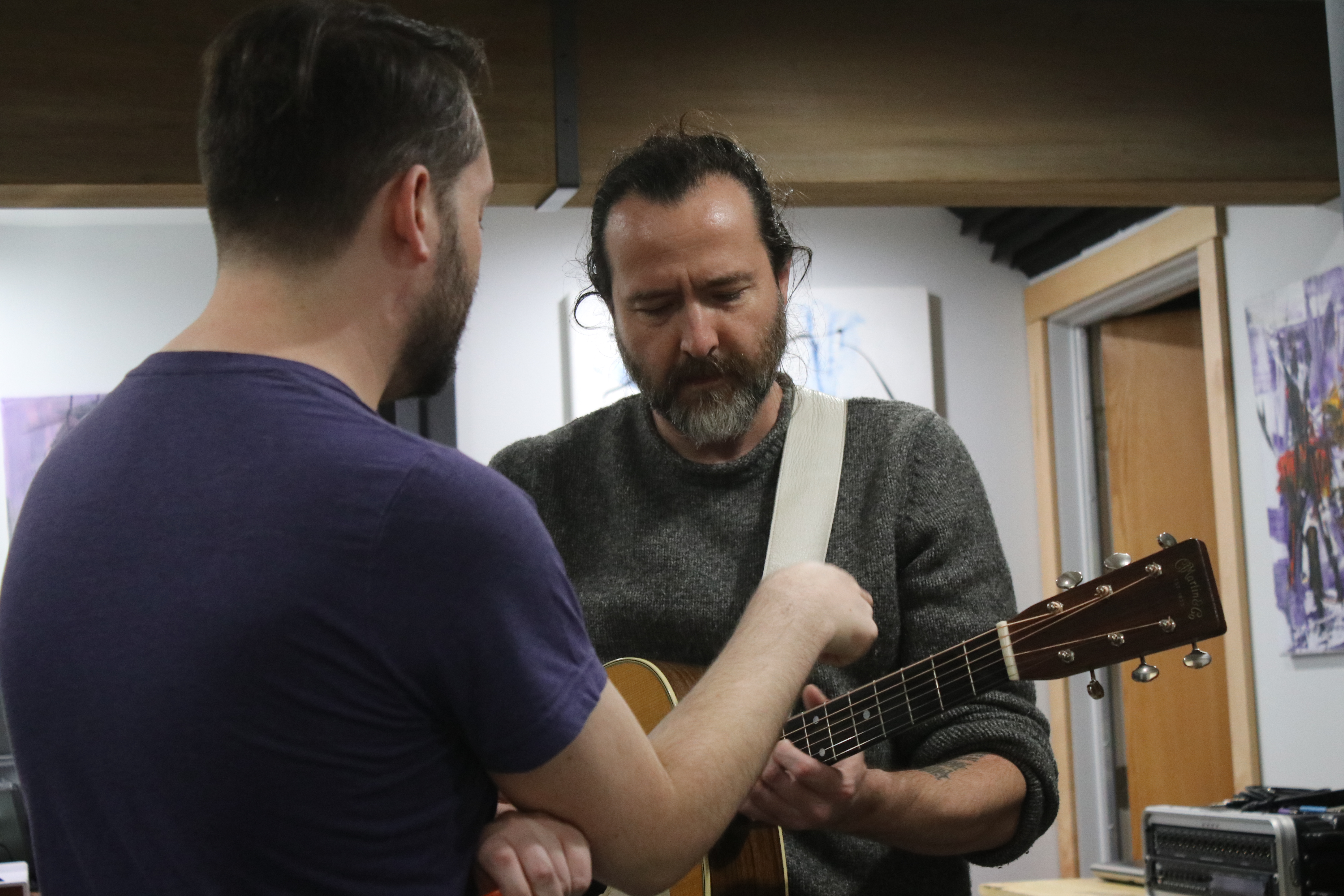 David and Sean discussing a guitar