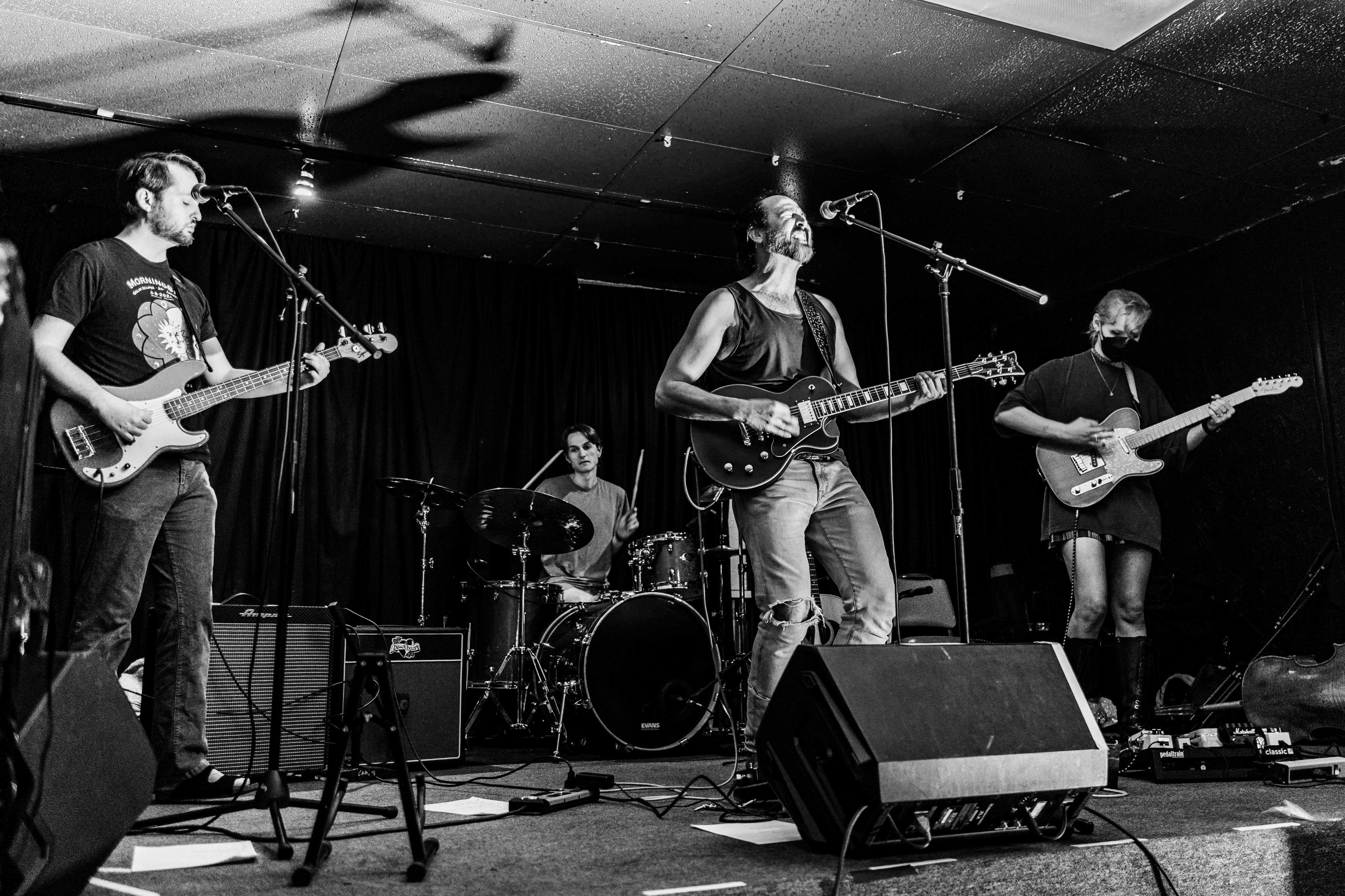 Wide shot of Carcasso band during intense moment of a song
